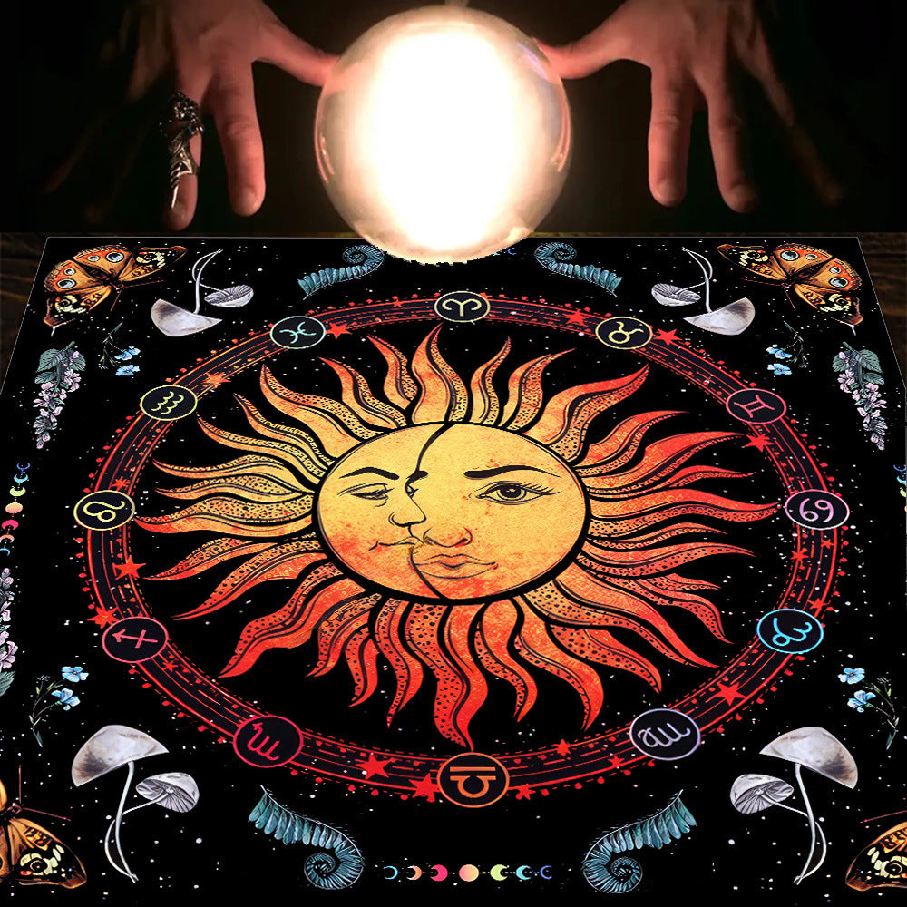 Decorative board with sun and moon design, surrounded by hands holding a crystal ball on a dark background.