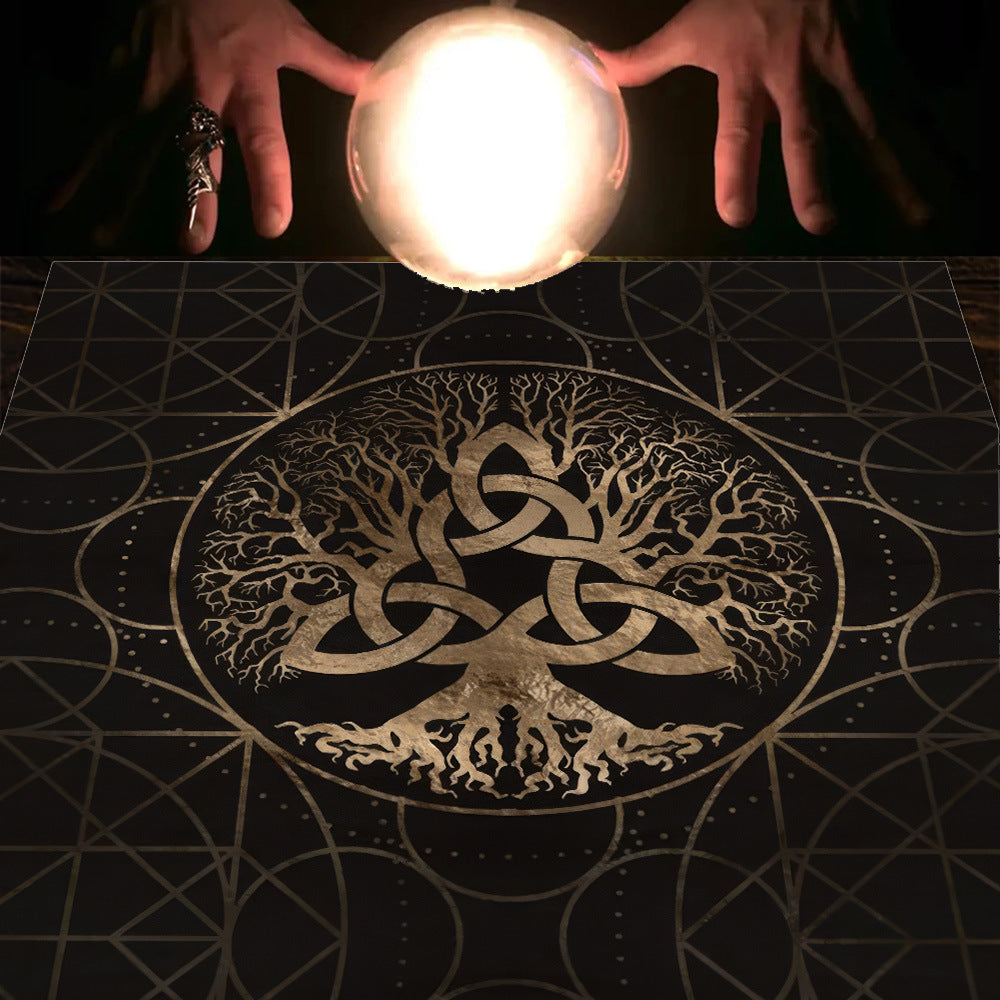 Two hands holding a glowing crystal ball over a mystical design with a tree of life and Celtic knot on a dark surface.
