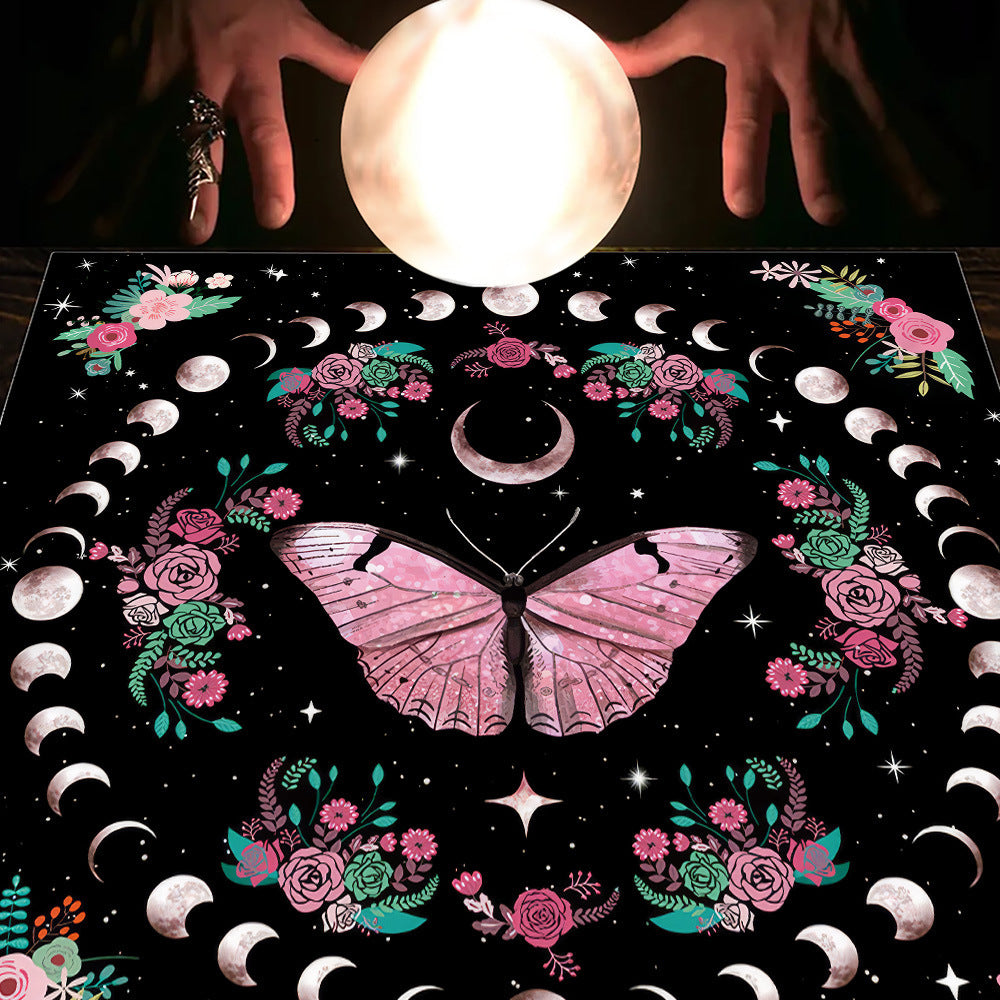 Decorative mat with butterfly design, flowers, and moon phases on a dark background.