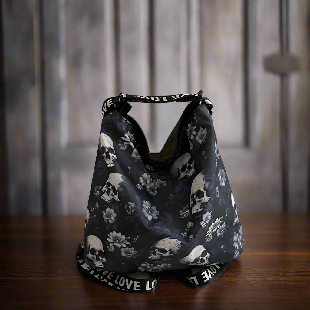 Black bag with skull and floral pattern on a wooden surface