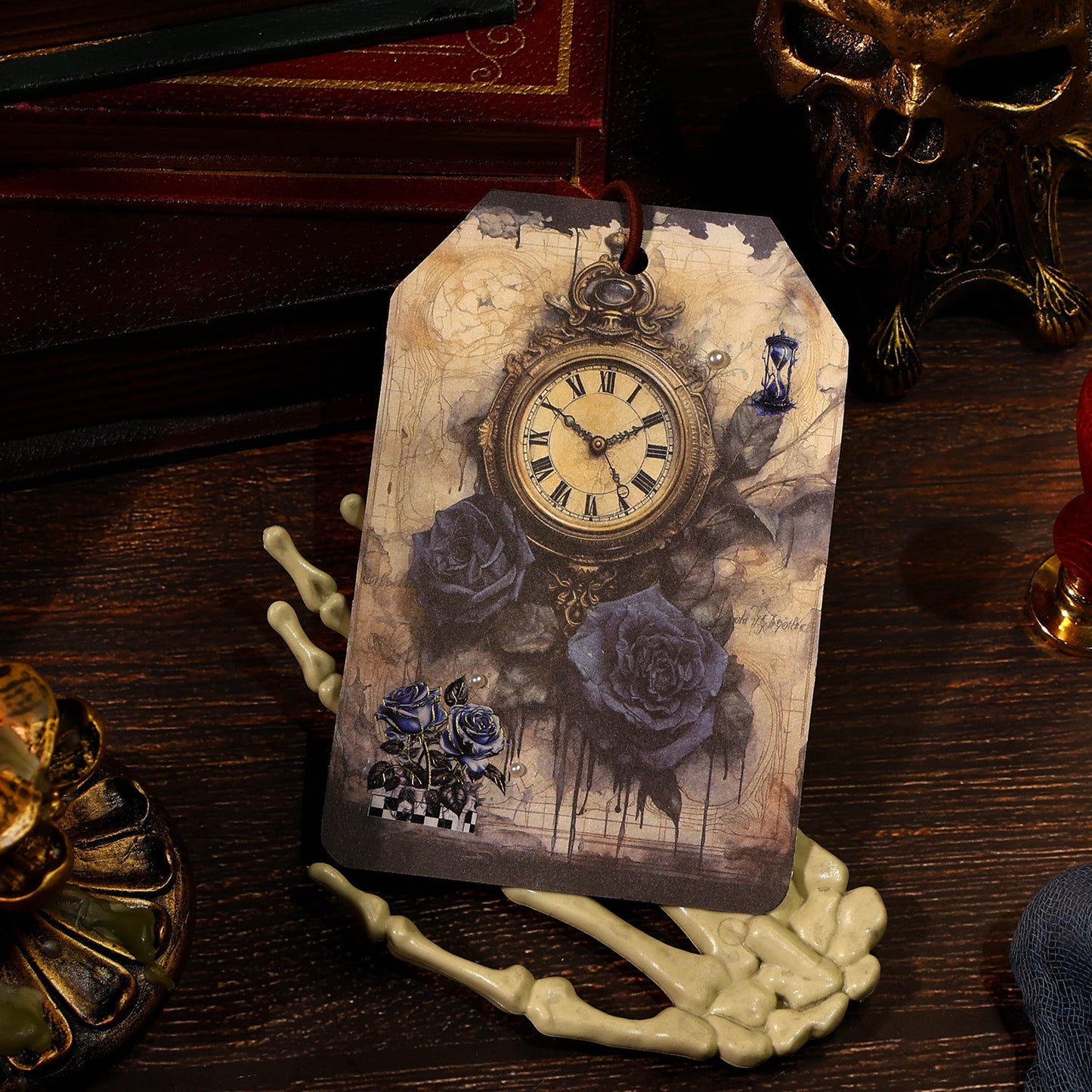 Decorative tag with a vintage clock design on a dark surface with skull and candle elements.
