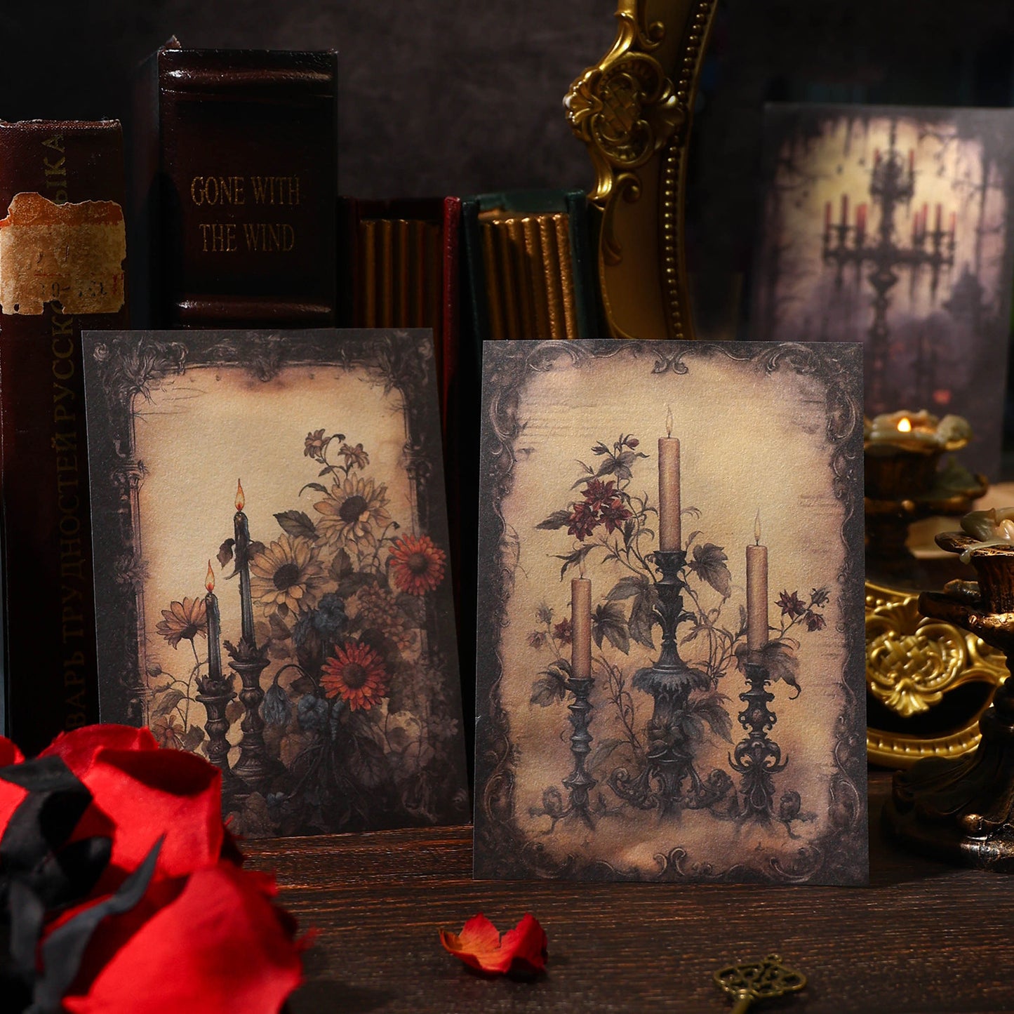 Two vintage-style greeting cards with floral and candle designs on a dark background with books and decorative items.