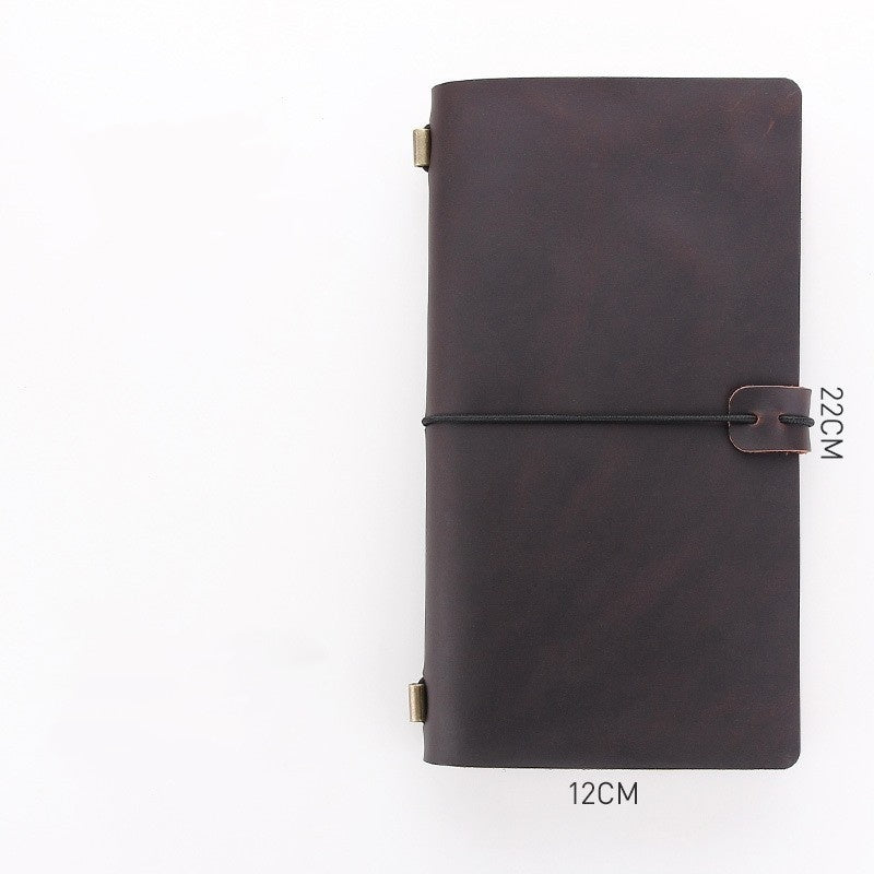 Dark brown leather notebook with strap closure on a white background