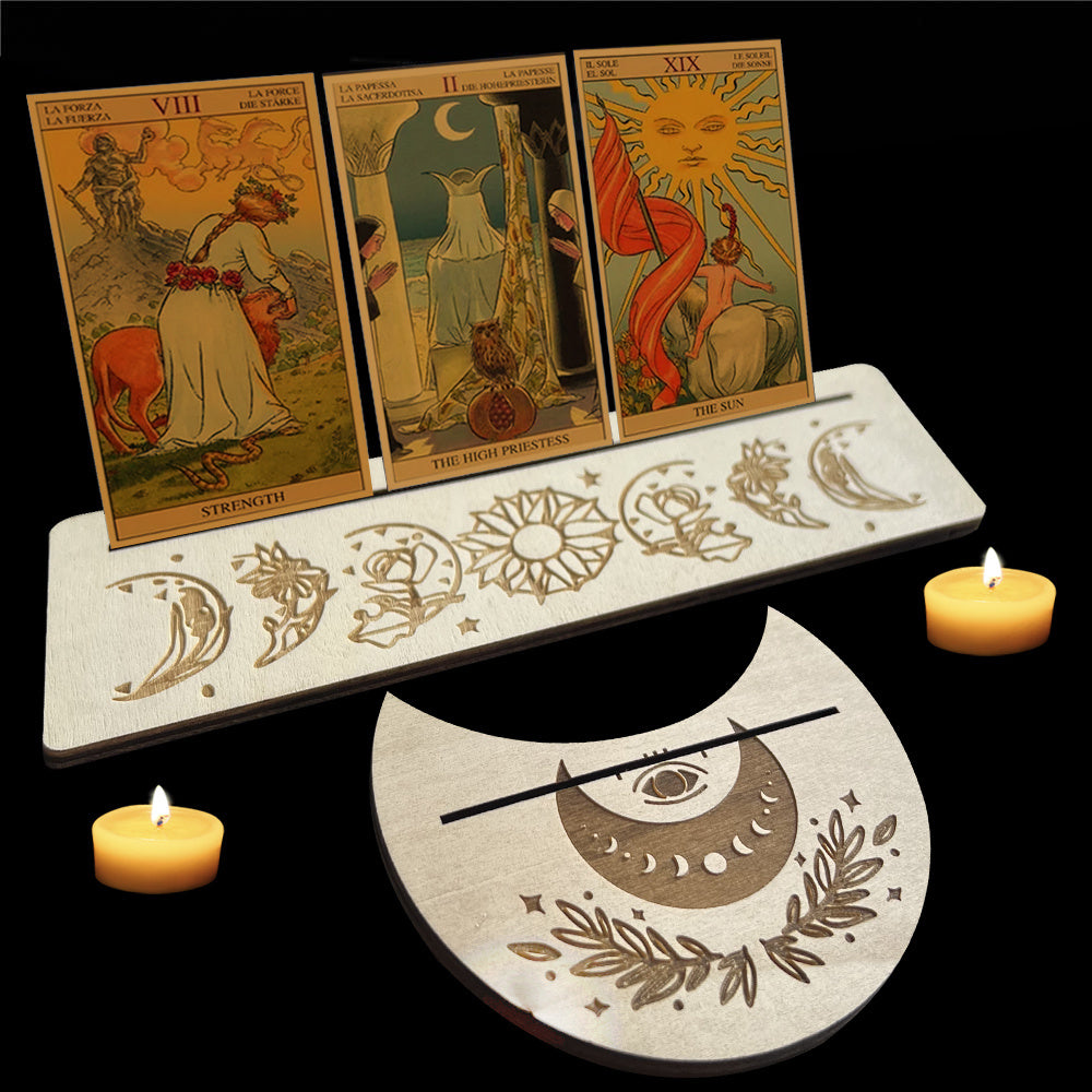 Three tarot cards on a stand with decorative elements and candles on a black background