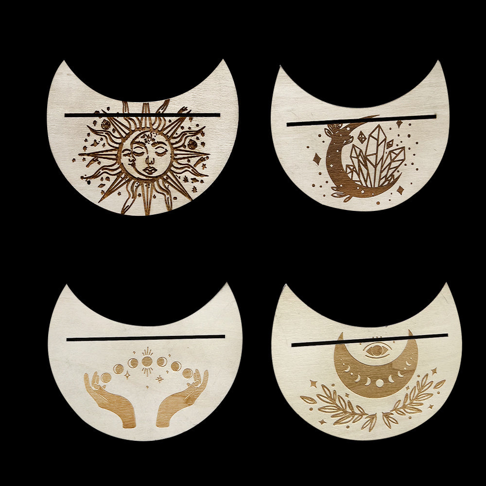 Four decorative elements with celestial designs on a black background
