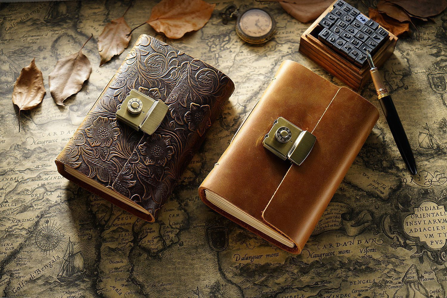 Two leather-bound books with metal clasps on an old map background