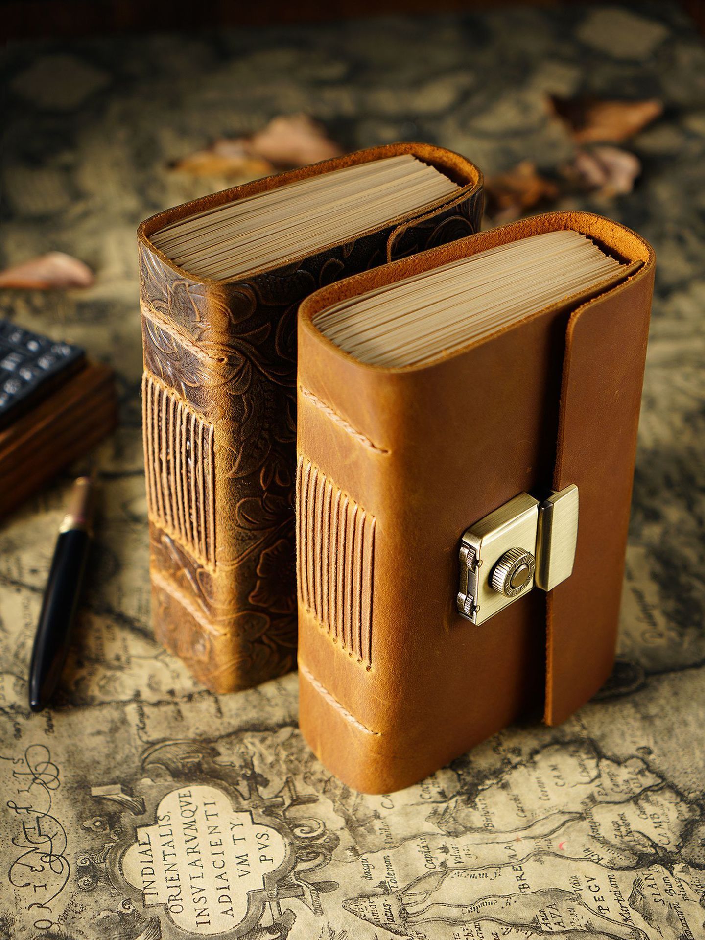 Two leather-bound books with a lock on an old map background