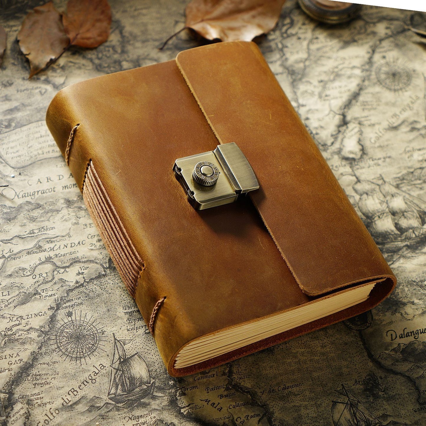 Brown leather notebook with a metal clasp on an old map background