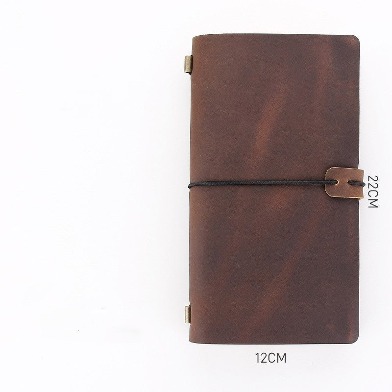 Brown leather notebook with a strap on a white background