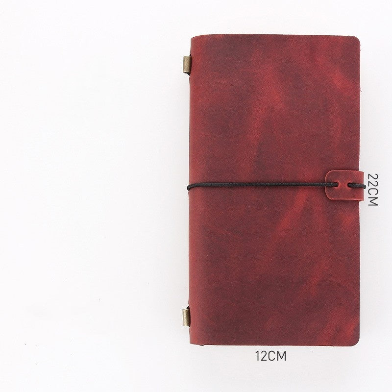 Red leather notebook with a strap on a white background