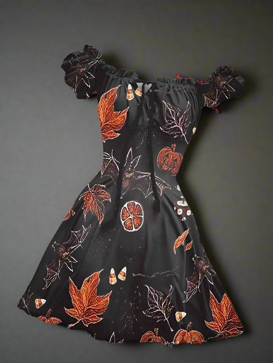 Black dress with autumn leaf and pumpkin pattern on a white background