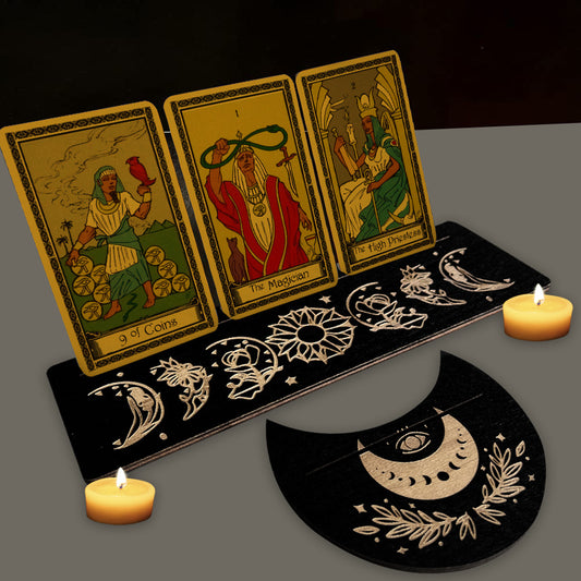 Three tarot cards on a decorative stand with candles and a black background