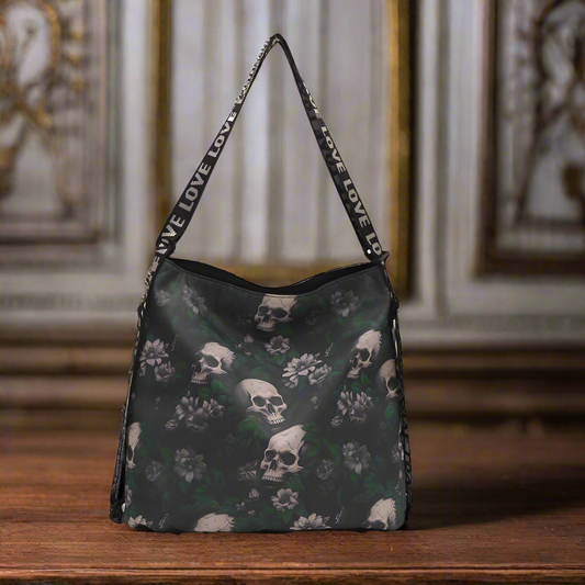 Handbag with skull and floral pattern on a wooden surface