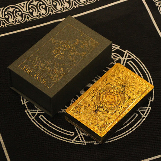 Gold tarot card with intricate designs on a black background