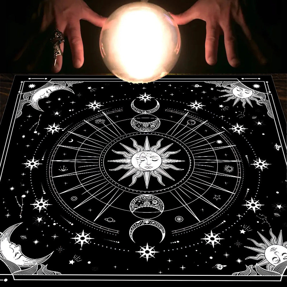 Person holding a crystal ball over a black and white astrological design